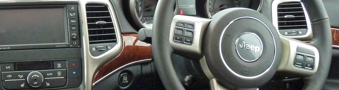 dashboard of a vehicle showing a drivers steering wheel